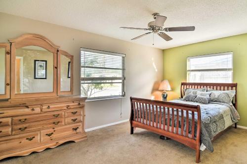 a bedroom with a bed and a dresser and a fan at Bradenton Snowbird Sanctuary with Covered Patio and Grill in Bradenton