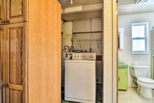 a kitchen with a refrigerator and a toilet at Bradenton Snowbird Sanctuary with Covered Patio and Grill in Bradenton