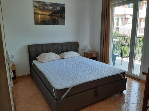 Ένα ή περισσότερα κρεβάτια σε δωμάτιο στο Apartments Macaso