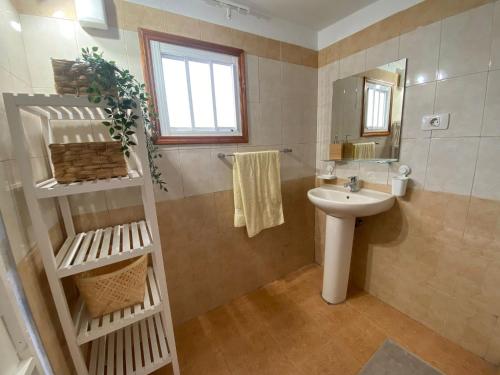 a bathroom with a sink and a mirror at B&B and Apartments El Charco Azul in El Risco