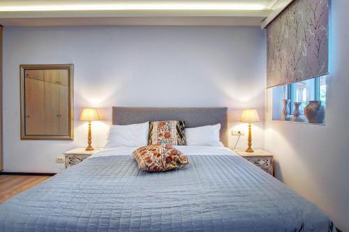 a bedroom with a large bed with a pillow on it at The Love Villa in Kassiopi