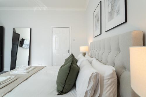 a bedroom with a large white bed with pillows at Southview Stays - Three bedroom House in Chester