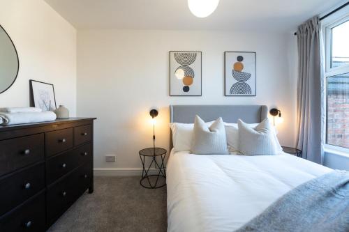 a bedroom with a white bed and a window at Southview Stays - Three bedroom House in Chester