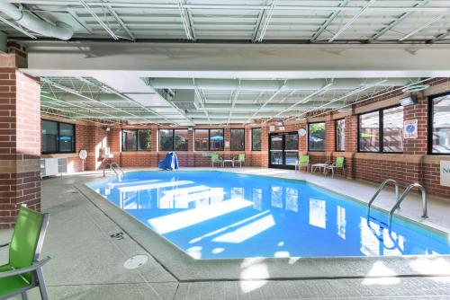 a large swimming pool in a building at Holiday Inn Express Naperville, an IHG Hotel in Naperville