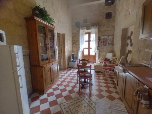 a kitchen with a red and white checkered floor at Villa Vittoria in Rabat