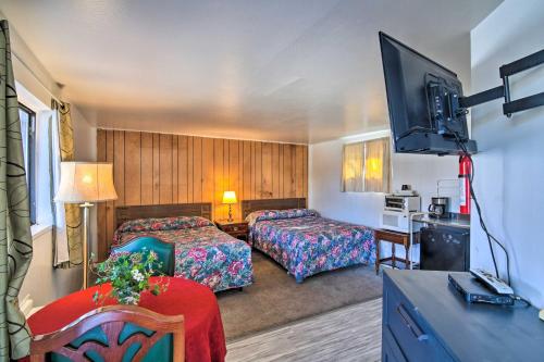 a hotel room with two beds and a flat screen tv at Pet-Friendly Vacation Rental Near Boyd Lake in Loveland