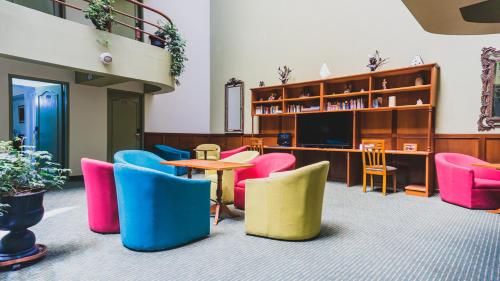 a waiting room with colorful chairs and a table at Faraona Grand Hotel in Lima