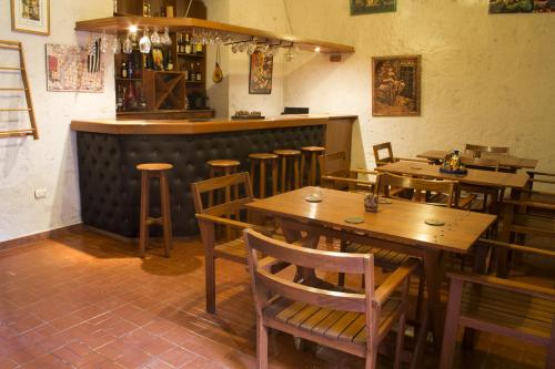 a restaurant with wooden tables and chairs and a bar at Posada Nueva España in Arequipa