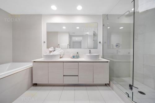 a white bathroom with two sinks and a shower at Beachwalk Resort #2102 - OCEAN VIEW WRAP AROUND BALCONY 3BD - 3BR CONDO No Resort and Parking Fees in Hallandale Beach