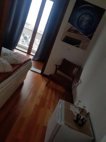 a room with a bed and a table and a window at Bressa de Ma affittacamere, room & breakfast in Pietra Ligure