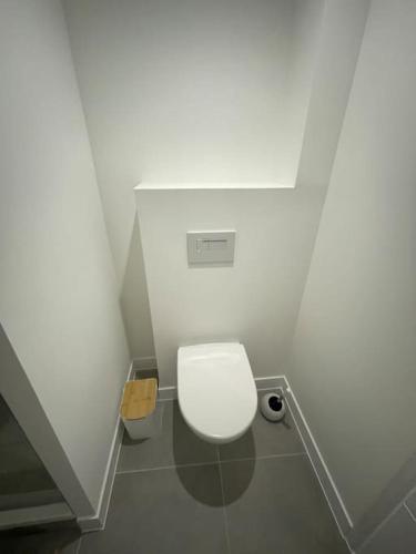 a bathroom with a white toilet in a stall at Le p tit Marin proche marché central et gare SNCF- wifi haut débit - in La Rochelle