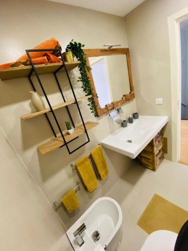 a bathroom with a sink and a mirror at Rooms Cabedelo Beach Loft in Darque