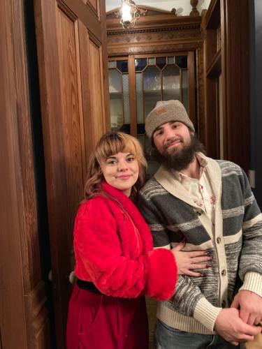 a man and a woman standing in front of a door at Coppersmith Inn Bed And Breakfast in Galveston
