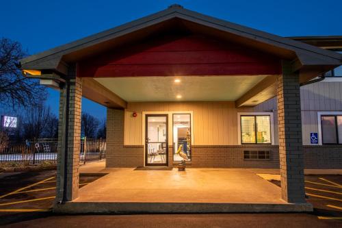 a front entrance to a building with a door at Hilltop Inn & Suites in Grove