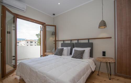a bedroom with a large bed and a large window at Adriana di Levante by "elite" in Ayios Kirikos