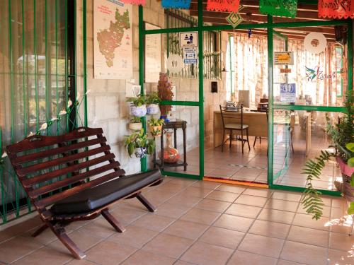 a bench sitting in front of a store with a window at Hotel Quinta Mirador Zacualli in Bernal
