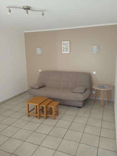 sala de estar con sofá y mesa en Logement cosy proche de la mer et des commodités, en Pleuven