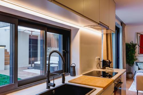 a kitchen with a sink and a window at Design Antas Home in Porto