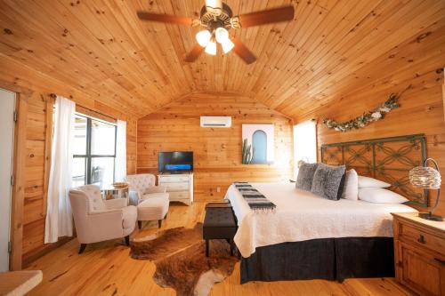 a bedroom with a bed and a ceiling fan at City on a Hill at Spring Creek in Fredericksburg