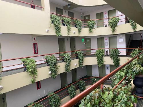 an apartment building with plants on the balconies at Faraona Grand Hotel in Lima