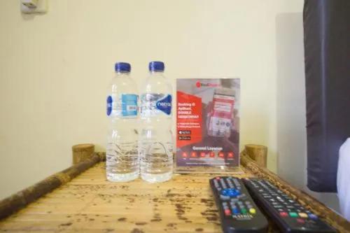 two bottles of water and two remote controls on a table at MURSYS PLACE in Kuta Lombok