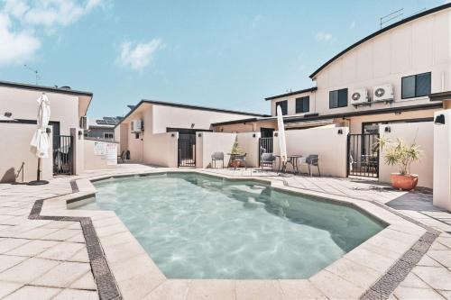 a swimming pool in the middle of a courtyard at 4-21 Maple Lane in Evans Head