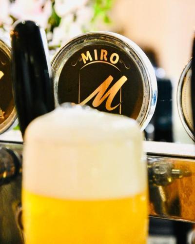 a glass of beer sitting on top of a table at Miro B&B in Lecce