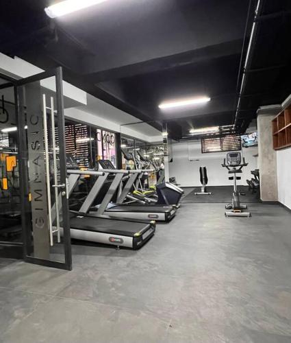 a gym with several treadmills and machines in a room at Departamento nuevo en el corazón de la Condesa in Mexico City