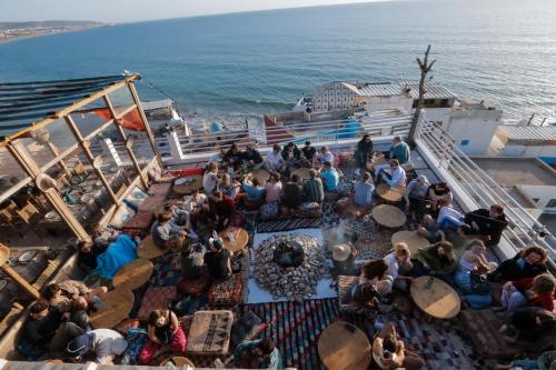 a group of people sitting on the deck of a cruise ship at Locals Taghazout surfcamp in Taghazout