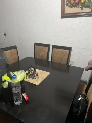 a black table with a bottle of water and chairs at Habitacion compartida Martires de Tlatelolco in Mexico City