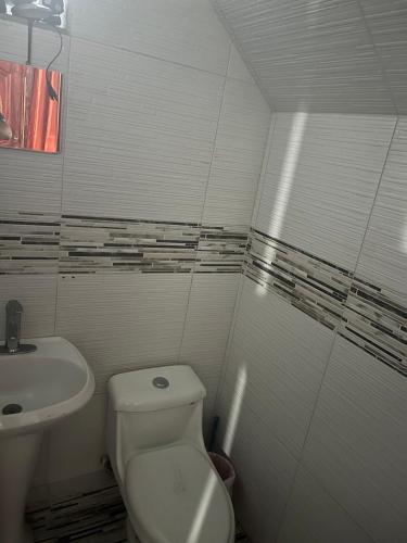 a bathroom with a toilet and a sink at Habitacion compartida Martires de Tlatelolco in Mexico City