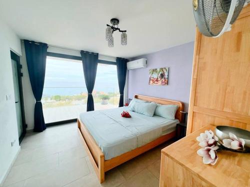 a bedroom with a bed and a large window at NEU!!! Apartment im Luxory Resort Coral Estate in Willibrordus