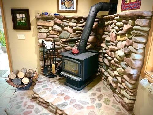 a stone wall with a stove in a room at Moss Mountain Inn in Columbia Falls