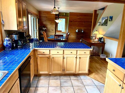 a kitchen with wooden cabinets and a blue counter top at Moss Mountain Inn in Columbia Falls