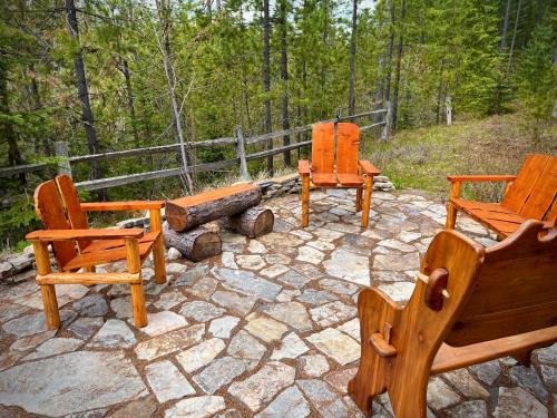 a group of chairs sitting on a stone patio at Moss Mountain Inn in Columbia Falls