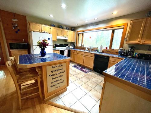 a kitchen with a island with a blue counter top at Moss Mountain Inn in Columbia Falls