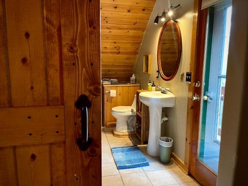 a bathroom with a white toilet and a sink at Moss Mountain Inn in Columbia Falls