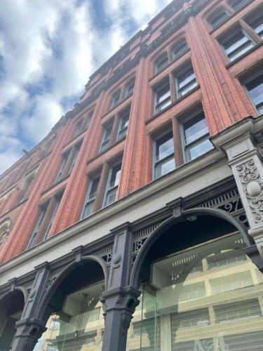 a red brick building with a street light in front of it at High Street Town House in Manchester