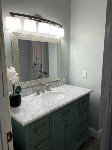 a bathroom with a sink and a mirror at Two-Bedroom Apartment in St. Petersburg