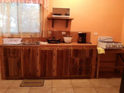 a kitchen with a wooden counter top with a sink at Casa del Eucalipto in Sabana Redonda