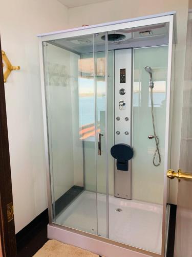 a shower with a glass door in a bathroom at Uros Titicaca Lodge in Puno