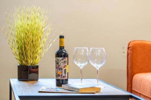 a bottle of wine and two wine glasses on a table at High Street Town House in Manchester