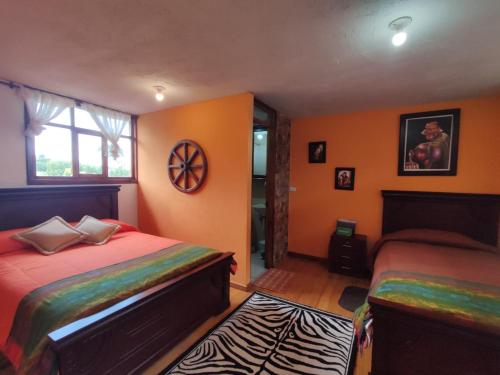 a bedroom with two beds and a window at Ruta de los volcanes in Machachi