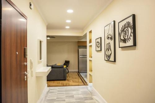 a hallway with a door leading to a living room at The Parthenon Terrace ReNoVaTeD with a view ! in Athens