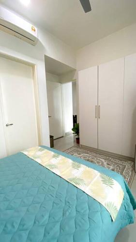 a bedroom with a blue bed in a room at The Icon 3 Condo in IOI City Mall Putrajaya, Pool View in Putrajaya