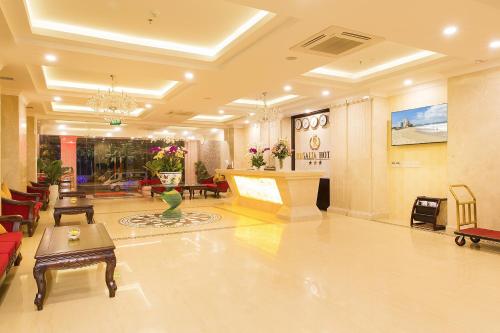 a lobby of a hotel with a table and chairs at Regalia Nha Trang in Nha Trang