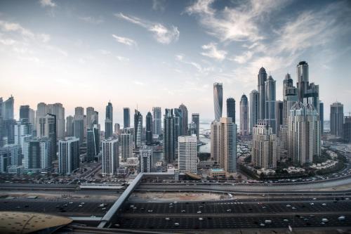 a view of a large city with many tall buildings at Pullman Dubai Jumeirah Lakes Towers in Dubai