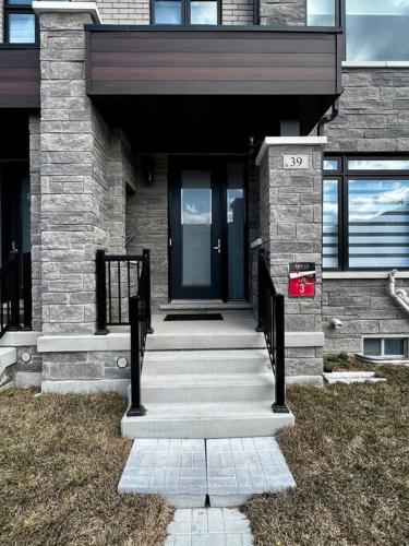 a front door of a house with a staircase at New Luxurious Studio Apartment in Brampton