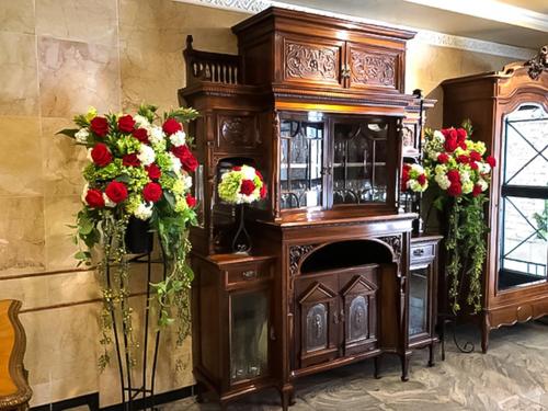 a large wooden cabinet with flowers on the wall at Rose Lips Shinsaibashi ローズリップス心斎橋 in Osaka