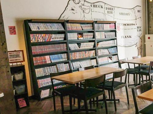 a library with several shelves filled with dvds at Hotel Abest Osu Kannon Ekimae Hane no Yu in Nagoya